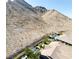 Picturesque home with a backyard oasis, featuring a sparkling pool and lush green landscaping at 2927 The Peaks Ln, Las Vegas, NV 89138