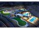 Stunning aerial view of community clubhouse, pool, and tennis courts at night at 2927 The Peaks Ln, Las Vegas, NV 89138
