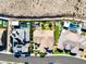 Aerial view of a property showcasing a putting green, pool, covered patio, and meticulous landscaping at 2927 The Peaks Ln, Las Vegas, NV 89138