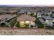 Aerial view of a property featuring a putting green, pool, covered patio, and lush landscaping at 2927 The Peaks Ln, Las Vegas, NV 89138