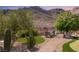 Inviting backyard featuring a putting green, desert landscaping, seating, and mountain views at 2927 The Peaks Ln, Las Vegas, NV 89138