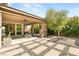 Spacious backyard with a covered patio, mature trees, and seamless indoor-outdoor living at 2927 The Peaks Ln, Las Vegas, NV 89138