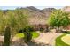 Serene backyard with a putting green, desert landscaping, and a cozy seating area with mountain views at 2927 The Peaks Ln, Las Vegas, NV 89138