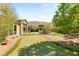 Lush backyard with a putting green, mature trees, outdoor seating, and a picturesque view at 2927 The Peaks Ln, Las Vegas, NV 89138