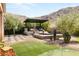 Beautiful backyard features a putting green, spa, and covered patio with outdoor seating, perfect for entertaining at 2927 The Peaks Ln, Las Vegas, NV 89138