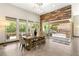 Dining room showcasing a wooden table, bench, and patio access at 2927 The Peaks Ln, Las Vegas, NV 89138
