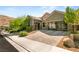 Lovely home with a three-car garage, beautiful desert landscaping, and a brick driveway at 2927 The Peaks Ln, Las Vegas, NV 89138