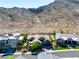Stunning single-Gathering home nestled beneath a rocky mountain backdrop with lush landscaping and a paved driveway at 2927 The Peaks Ln, Las Vegas, NV 89138