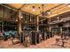 Modern fitness center with high ceilings, extensive equipment, and large windows overlooking the pool at 2927 The Peaks Ln, Las Vegas, NV 89138