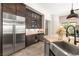 Modern kitchen with stainless steel refrigerator, wine cooler, and granite countertops at 2927 The Peaks Ln, Las Vegas, NV 89138