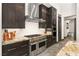 Chef's kitchen with a high-end range, stainless steel hood, and custom cabinetry at 2927 The Peaks Ln, Las Vegas, NV 89138