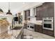 Well-equipped kitchen featuring custom cabinetry, granite counters, and stainless steel appliances at 2927 The Peaks Ln, Las Vegas, NV 89138