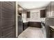Laundry room featuring dark cabinets, stainless steel washer and dryer at 2927 The Peaks Ln, Las Vegas, NV 89138
