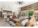Cozy living room with a large rug, comfortable seating, and access to an outdoor patio at 2927 The Peaks Ln, Las Vegas, NV 89138
