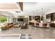 Open-concept living area boasts fireplace, built-ins, tile floors, and a modern kitchen at 2927 The Peaks Ln, Las Vegas, NV 89138