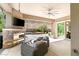 An outdoor living space with a stone fireplace, ample seating and mountain views at 2927 The Peaks Ln, Las Vegas, NV 89138