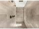 Walk-in shower features designer tile and multiple shower heads at 2927 The Peaks Ln, Las Vegas, NV 89138