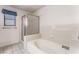 Bathroom featuring a soaking tub and a glassed-in shower at 3108 Leafwood St, Las Vegas, NV 89108