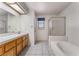 Bathroom featuring a double sink vanity, a soaking tub, and a glassed-in shower at 3108 Leafwood St, Las Vegas, NV 89108