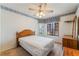 Bedroom featuring a window view, ceiling fan, and dresser at 3108 Leafwood St, Las Vegas, NV 89108