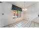 Eat-in kitchen space featuring tile flooring, a chandelier and a large window at 3108 Leafwood St, Las Vegas, NV 89108