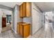 Hallway leading to the living room with tile flooring and wooden cabinets at 3108 Leafwood St, Las Vegas, NV 89108
