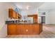 Bright kitchen with granite countertops, wooden cabinets, and stainless-steel appliances at 3108 Leafwood St, Las Vegas, NV 89108