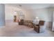 Spacious living room featuring plush carpeting, large windows, and comfortable seating at 3108 Leafwood St, Las Vegas, NV 89108