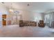Bright living room with neutral carpet, large windows, and comfortable seating at 3108 Leafwood St, Las Vegas, NV 89108
