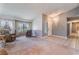 Comfortable living room with carpet, natural light, and a view into the entry and beyond at 3108 Leafwood St, Las Vegas, NV 89108