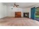 Open living room with a ceiling fan, a black marble fireplace and a cabinet at 3108 Leafwood St, Las Vegas, NV 89108