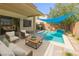 A luxurious backyard pool with an outdoor seating area for relaxation and entertaining guests at 3440 Bella Viera Ct, Las Vegas, NV 89141