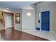 Inviting entryway with a bright blue door, a mirror, and hardwood flooring at 3440 Bella Viera Ct, Las Vegas, NV 89141