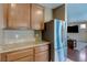 Kitchen area features stainless steel refrigerator, light granite counters, and lots of cabinet space at 3440 Bella Viera Ct, Las Vegas, NV 89141