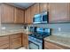 Kitchen area boasts stainless steel oven/stove and microwave with granite countertops and lots of cabinet space at 3440 Bella Viera Ct, Las Vegas, NV 89141