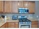 Kitchen area with stainless steel oven/stove and microwave and ample cabinet space and granite countertops at 3440 Bella Viera Ct, Las Vegas, NV 89141