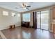 Bright living area with hardwood floors, ceiling fan, and sliding glass doors that offer access to the pool at 3440 Bella Viera Ct, Las Vegas, NV 89141