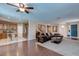 Expansive living room with a sectional sofa, open to the kitchen, dining area, and foyer with a vibrant blue door at 3440 Bella Viera Ct, Las Vegas, NV 89141