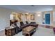 Inviting living room with a large sectional sofa, leading to the dining area and a bright blue front door at 3440 Bella Viera Ct, Las Vegas, NV 89141