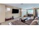 Cozy living room setup with a large TV, comfortable seating, and natural light from multiple windows at 3440 Bella Viera Ct, Las Vegas, NV 89141
