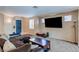 Spacious living room with a comfortable sofa, a large TV, and lots of natural light at 3440 Bella Viera Ct, Las Vegas, NV 89141