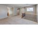 Bright upstairs loft area with neutral carpet, railings, and a window providing natural light at 3440 Bella Viera Ct, Las Vegas, NV 89141