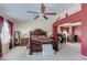 Large main bedroom with dark wood furniture, neutral carpet, and ceiling fan at 3440 Bella Viera Ct, Las Vegas, NV 89141
