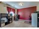 Office space with accent wall, shelving units, natural light, and a desk with rolling chair at 3440 Bella Viera Ct, Las Vegas, NV 89141
