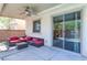 Covered patio area with ceiling fan, and comfortable seating, offering a relaxing outdoor living space with seamless indoor access at 3440 Bella Viera Ct, Las Vegas, NV 89141