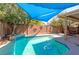 The pristine pool is ready for cooling off in the backyard of this home with a sun sail at 3440 Bella Viera Ct, Las Vegas, NV 89141