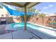 A refreshing backyard pool features a sun shade, creating an ideal space for outdoor relaxation and entertainment at 3440 Bella Viera Ct, Las Vegas, NV 89141