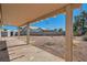 A spacious backyard showcasing a covered patio and a low-maintenance desert landscape at 3912 Branchwood Dr, North Las Vegas, NV 89032