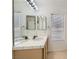 Bathroom featuring a double sink vanity, tile countertops, and large mirror at 3912 Branchwood Dr, North Las Vegas, NV 89032