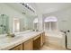 Bathroom featuring double sinks, vanity, a large mirror, and a tub at 3912 Branchwood Dr, North Las Vegas, NV 89032